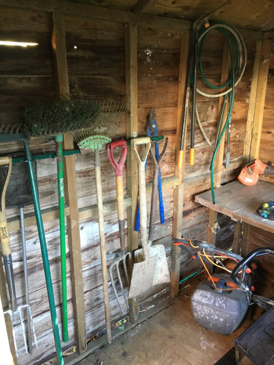 Long tools hanging on a shed wall