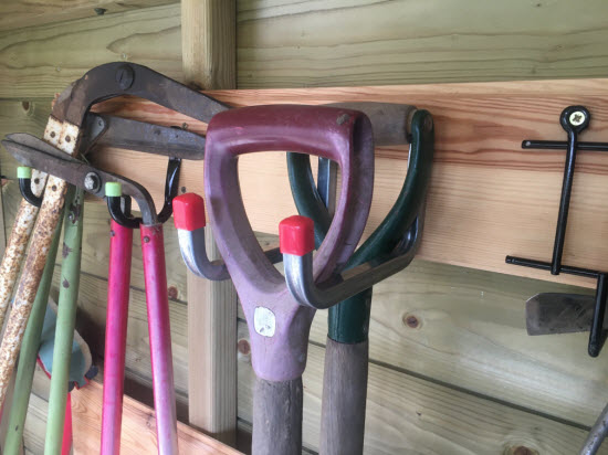 Hooks on a shed wall for hanging tools