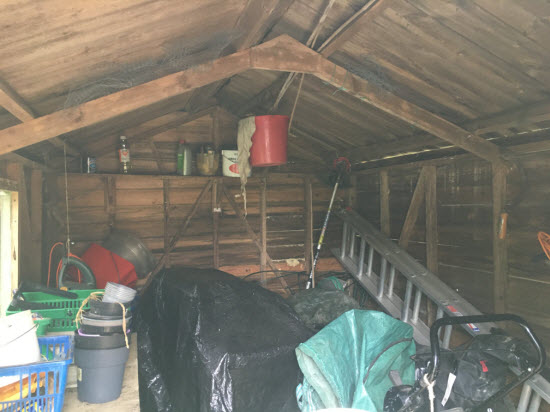 A disorganised shed with no shelving